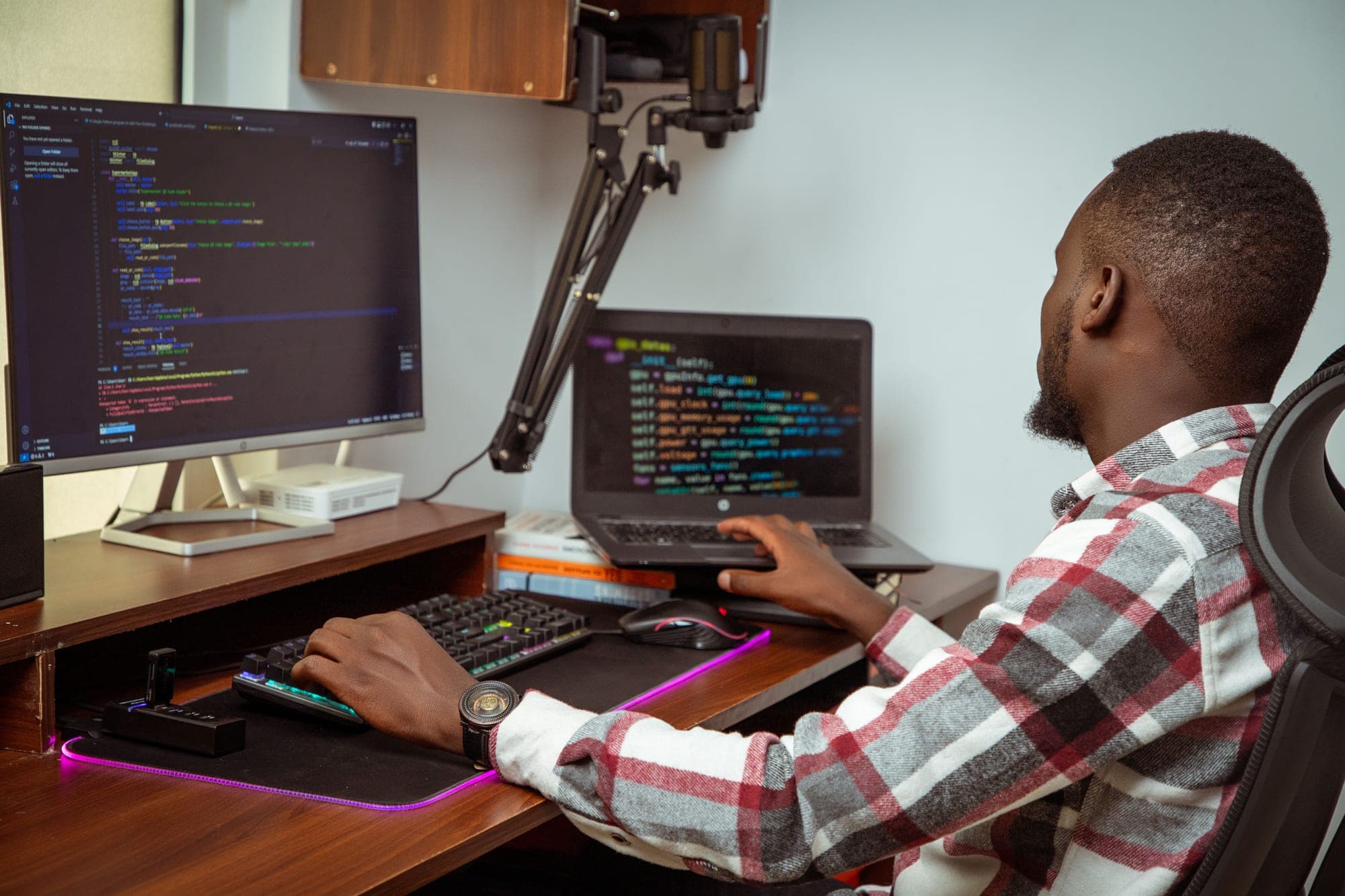 A MettWorks engineer working across a multi-monitor development setup